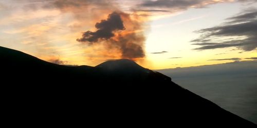 Scenic view of silhouette mountains against sky during sunset