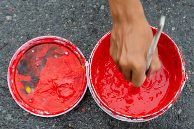 Low section of person wearing red shoes on street