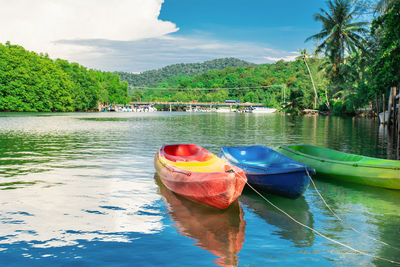 Boats moored in lake against sky