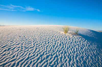 Scenic view of sand dune against sky