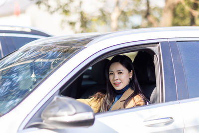 Portrait of woman sitting in car