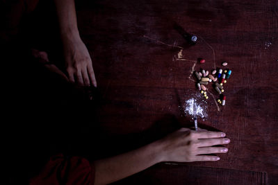 High angle view of hands holding glass of water