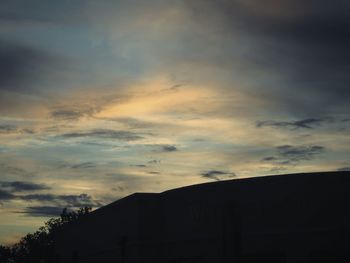 Low angle view of silhouette building against sky