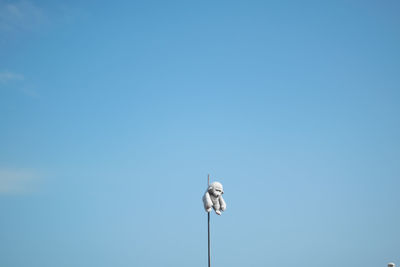 Low angle view of street light against clear blue sky