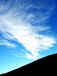 Low angle view of vapor trail in blue sky