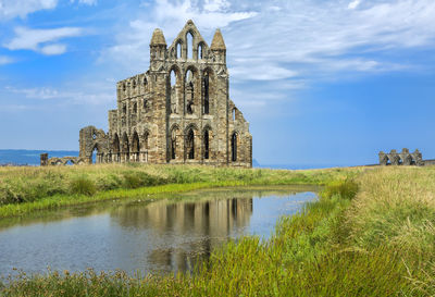 Built structure in water against sky