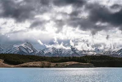 Gloomy landscape of new zealand southern alps and lake pukaki with blue sky and clouds.