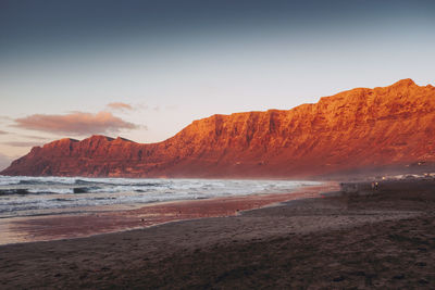 Scenic view of beach against sky during sunset