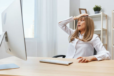 Portrait of young woman working at office