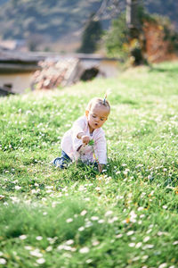 Cute girl on grass in field