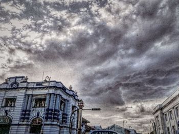 Low angle view of building against cloudy sky