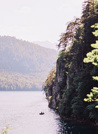 Scenic view of sea and mountains against sky