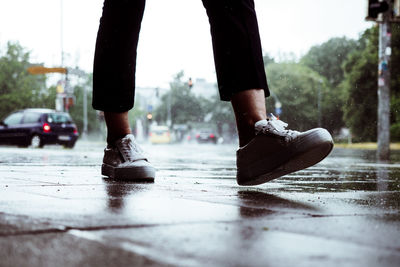 Low section of woman walking in street