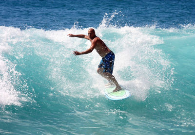 Full length of shirtless man in swimming pool