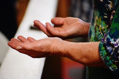 Cropped hands gesturing over table 