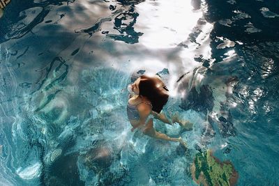 High angle view of woman swimming in pool