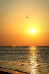 Scenic view of sea against orange sky