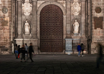 People walking in historic building