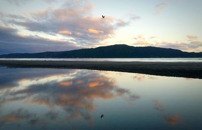 Scenic view of lake against sky during sunset