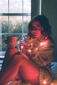 Young woman sitting at home