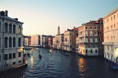 Sunset in florence with the view of gondolas floating in the river  