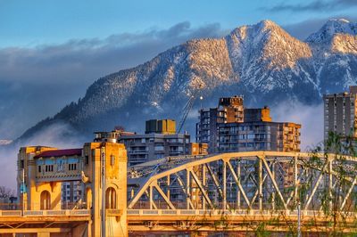 Panoramic shot of illuminated city against sky during winter