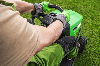 Low section of man holding grass