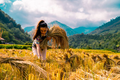 Young woman standing on field