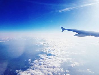 Aerial view of airplane wing against sky