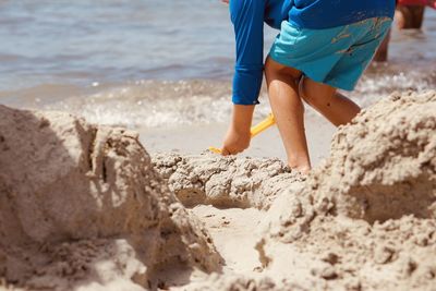 Low section of woman standing on beach