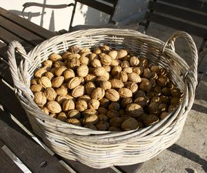 High angle view of wicker basket for sale at market walnuts