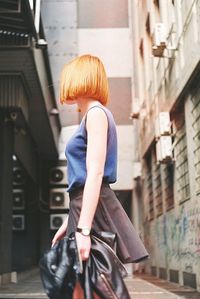 Rear view of woman standing in bus