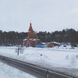 Snow covered building against sky