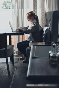 Focused businesswoman working remotely on her laptop computer contemplate managing her work