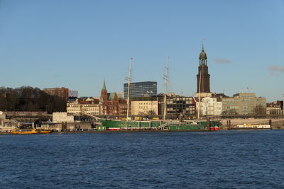 Buildings in city against clear sky