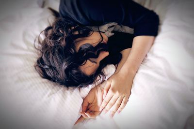 Close-up of woman lying on bed