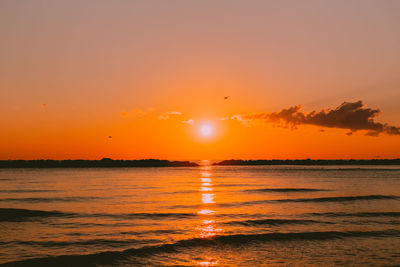 Scenic view of sea against romantic sky at sunset