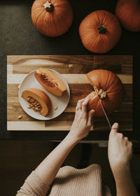 Cropped hand of woman cutting knife