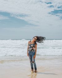 Woman with umbrella on beach