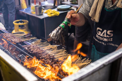 Man preparing food on barbecue grill