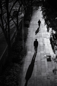 High angle view of people walking on footpath