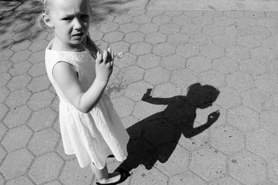 High angle view of girl with shadow on floor