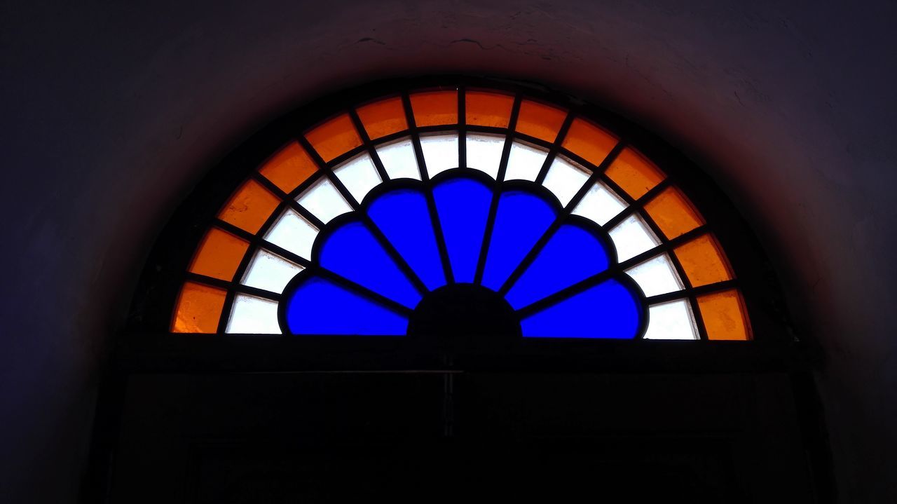 indoors, low angle view, ceiling, architecture, built structure, blue, circle, pattern, window, illuminated, arch, geometric shape, design, lighting equipment, directly below, stained glass, no people, multi colored, shape, glass - material