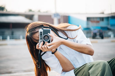 Portrait of woman photographing