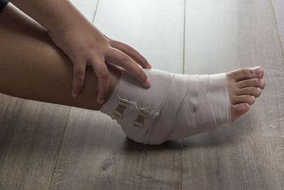 Low section of woman legs on floor