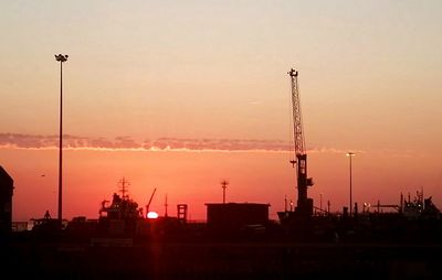 Silhouette cityscape against sky during sunset