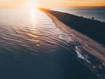 High angle view of sea against sky during sunset