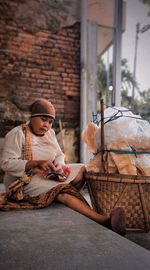 Man sitting on wicker basket