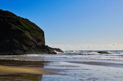 Scenic view of sea against clear blue sky