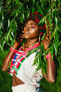 Woman standing on tree trunk